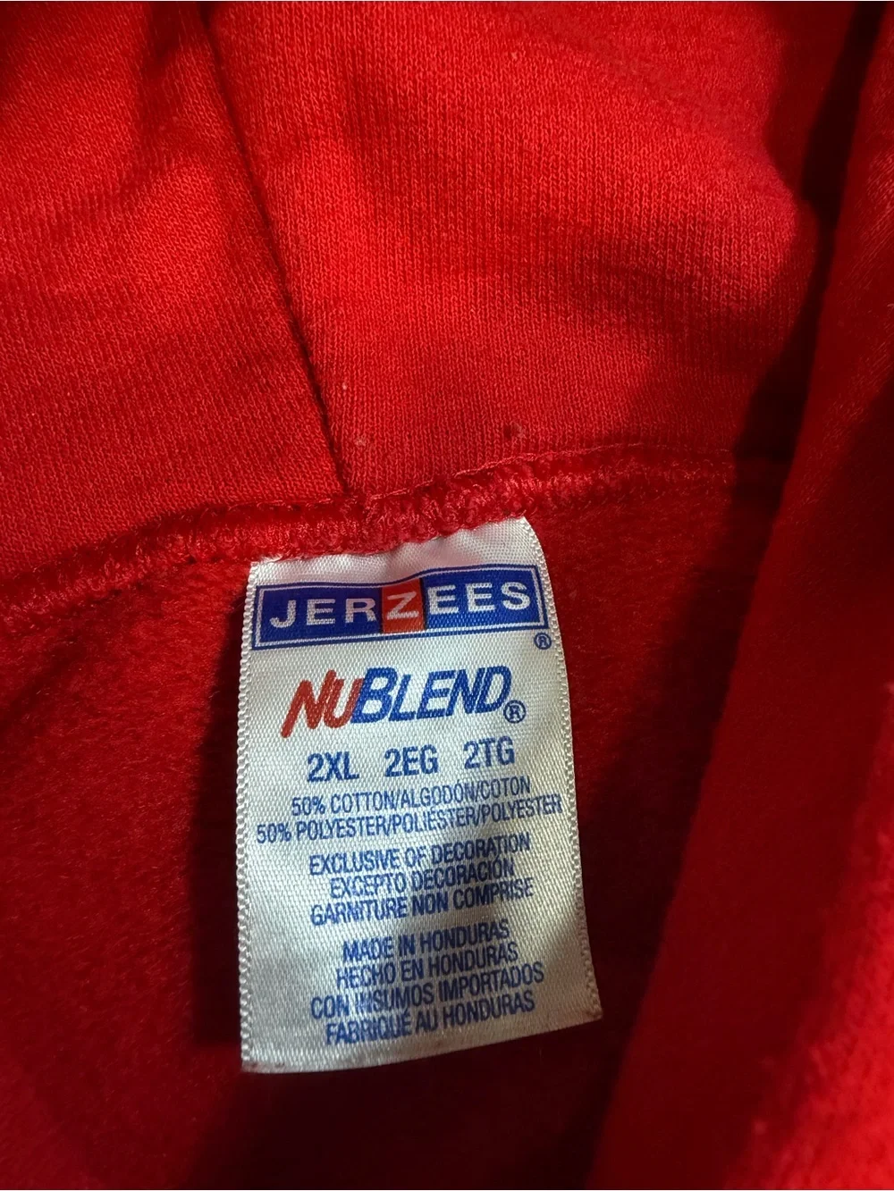 a red sweatshirt featuring a *Home Alone*-style print titled 